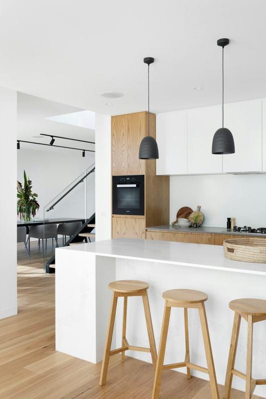 White kitchen with island and bar stools