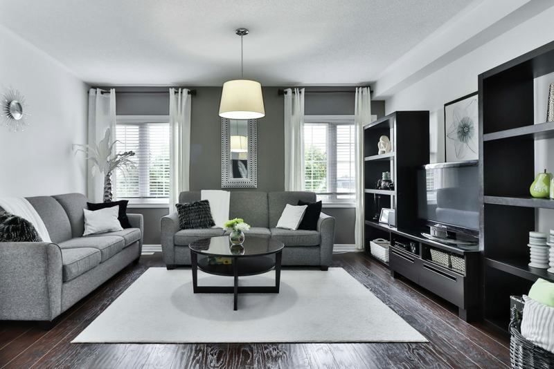 Grey living room with dark wood storage wall